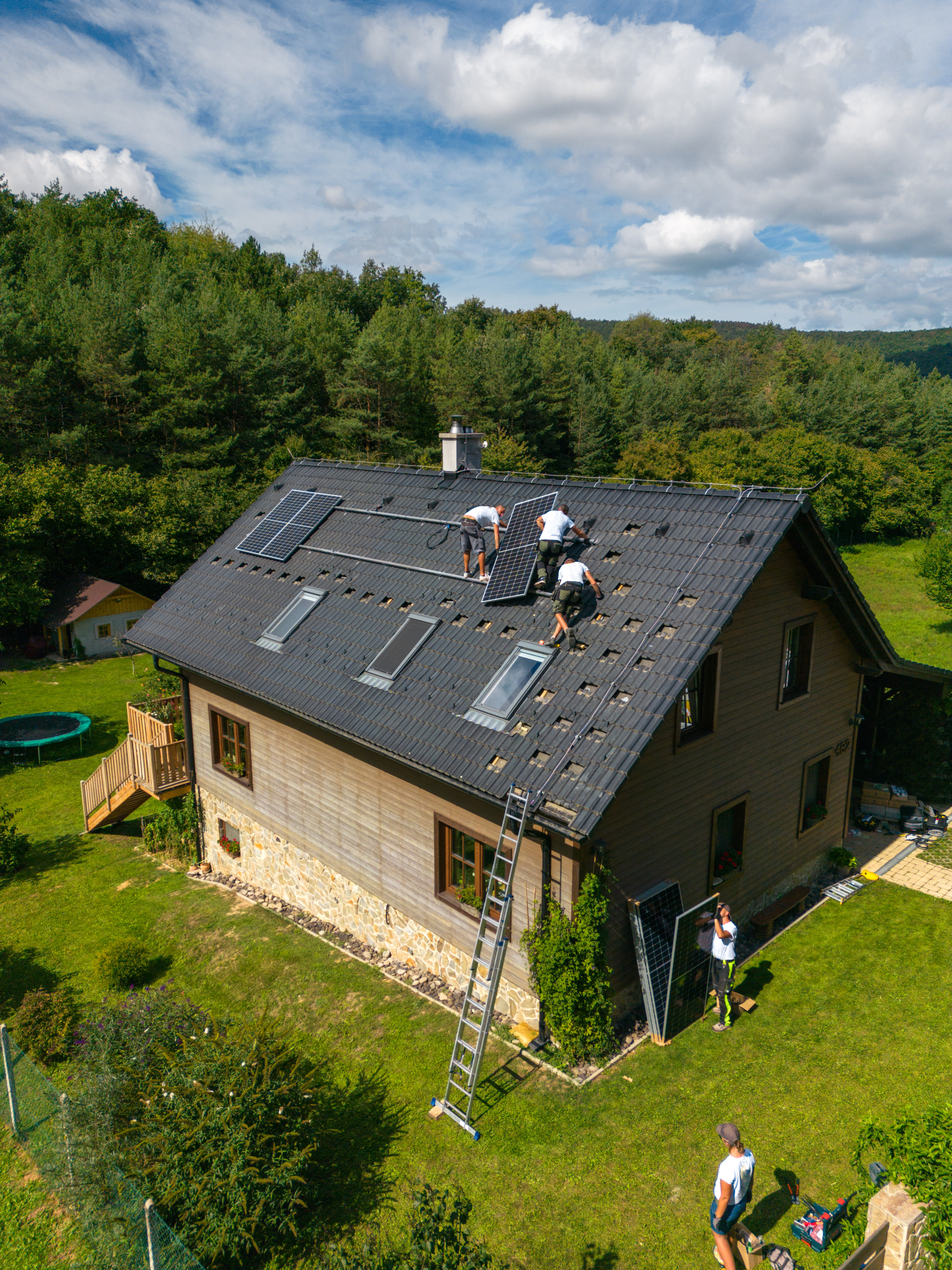 Men worker installing solar photovoltaic panels on roof, alternative energy, saving resources and sustainable lifestyle concept.